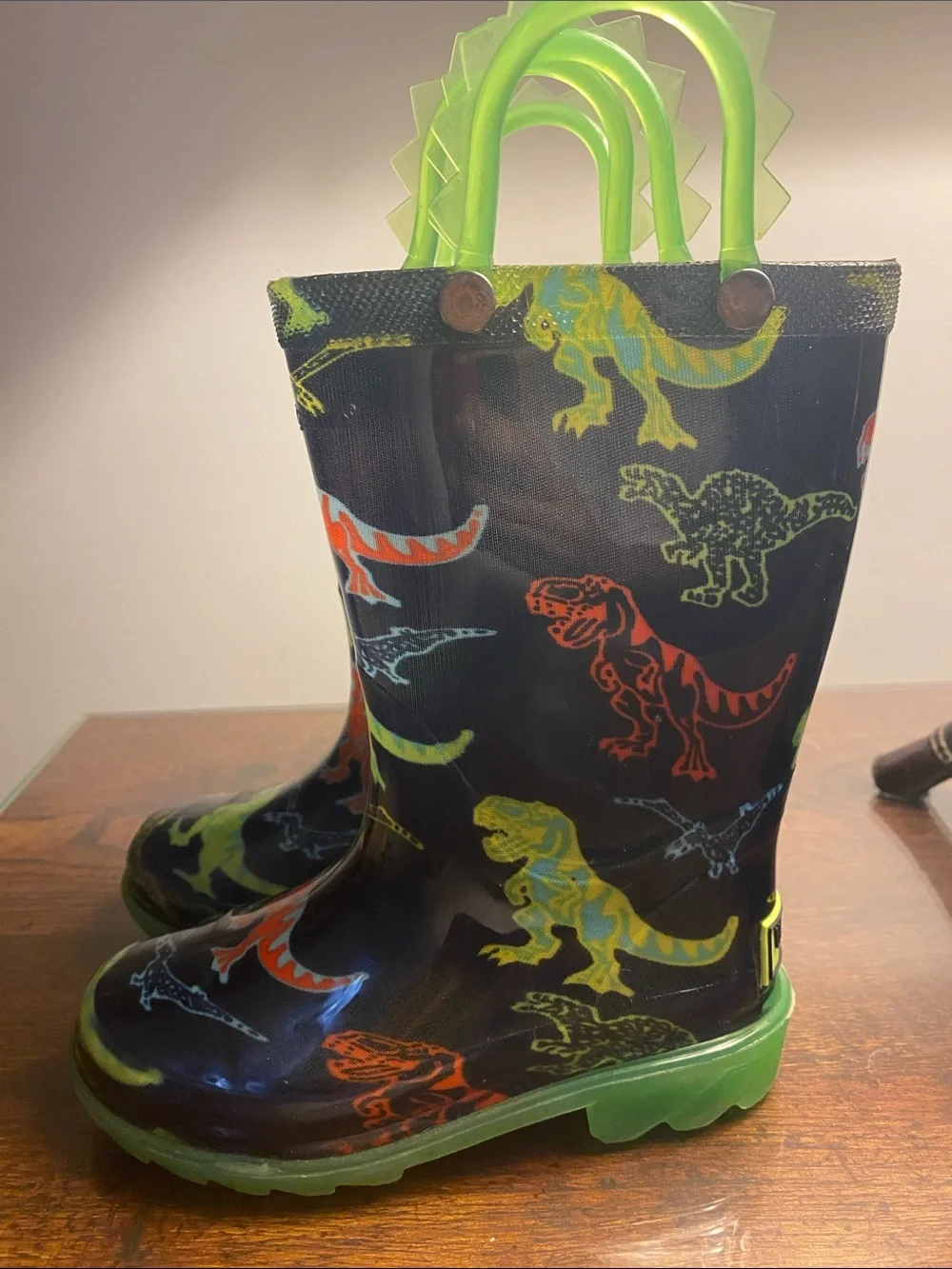 Western Chief Kids Black Rain Boots with Neon Green Handles and Accent Dinosaurs